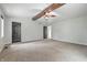 Spacious main bedroom featuring high ceilings with wooden beams, carpet, and multiple doorways at 1066 N Dogwood Way, Greenfield, IN 46140