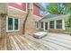 Spacious wooden deck featuring brick accents and a cozy outdoor seating area, perfect for entertaining at 1066 N Dogwood Way, Greenfield, IN 46140