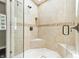 Beautiful glass enclosed shower featuring stone tiles, a seat, and alcove for storage at 1066 N Dogwood Way, Greenfield, IN 46140