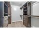 Walk-in closet with custom shelving and storage for clothing, shoes, and accessories at 1066 N Dogwood Way, Greenfield, IN 46140