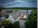 Scenic aerial view of a home near the lake, showcasing meticulous landscaping and waterfront access at 11137 Peppermill Ln, Fishers, IN 46037