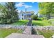 Expansive backyard with a private dock, staircase, lush lawn, and waterfront views at 11137 Peppermill Ln, Fishers, IN 46037