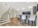 Finished basement area with a bar, seating, and a curved staircase at 11137 Peppermill Ln, Fishers, IN 46037
