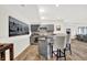 Basement bar featuring a wet bar with gray cabinets, marble countertops, and barstools at 11137 Peppermill Ln, Fishers, IN 46037