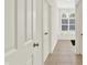 Hallway view leading to a well-lit bathroom featuring a bathtub and window at 11137 Peppermill Ln, Fishers, IN 46037