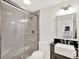 Modern bathroom boasts a tiled glass shower, gray vanity, and updated fixtures at 11137 Peppermill Ln, Fishers, IN 46037