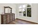 Bedroom showcasing hardwood floors and a dresser facing a window with a view of the lake at 11137 Peppermill Ln, Fishers, IN 46037