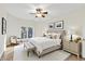 Stylish bedroom with neutral tones, a ceiling fan, decorative lamps, and large window at 11137 Peppermill Ln, Fishers, IN 46037
