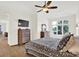 Cozy bedroom with lake views from the window, featuring hardwood floors and comfortable furnishings at 11137 Peppermill Ln, Fishers, IN 46037