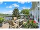 Outdoor deck has a lake view with potted plants, outdoor chairs, and a fire pit at 11137 Peppermill Ln, Fishers, IN 46037