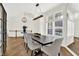 Bright dining room features a modern light fixture, elegant flooring, and a staircase leading to a second floor at 11137 Peppermill Ln, Fishers, IN 46037
