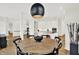 Spacious dining area adjacent to kitchen features hardwood floors, modern lighting, and open living area at 11137 Peppermill Ln, Fishers, IN 46037