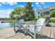 Waterfront view from a dock with chairs, showcasing the home's backyard and lake access at 11137 Peppermill Ln, Fishers, IN 46037