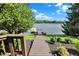 Scenic view of a private dock leading to a beautiful lake, surrounded by lush greenery at 11137 Peppermill Ln, Fishers, IN 46037