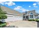 Spacious home with a three-car garage, well-maintained landscaping, and a brick-lined driveway at 11137 Peppermill Ln, Fishers, IN 46037