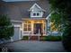 Charming home exterior with detailed trim, a covered entry, and well-maintained landscaping at 11137 Peppermill Ln, Fishers, IN 46037