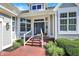 Charming front entrance with a brick walkway, manicured shrubs, and a stylish blue door at 11137 Peppermill Ln, Fishers, IN 46037