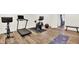 Spacious home gym in basement with modern equipment, a mirror, and laminate flooring at 11137 Peppermill Ln, Fishers, IN 46037