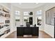Sunlit home office with a view of the lake, featuring a built-in bookshelf and large windows at 11137 Peppermill Ln, Fishers, IN 46037