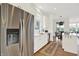 Bright kitchen features stainless steel appliances, white cabinets, and an island open to the dining area at 11137 Peppermill Ln, Fishers, IN 46037