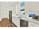Well-lit kitchen featuring white cabinets, countertops, stainless steel appliances, and a view to the outdoors at 11137 Peppermill Ln, Fishers, IN 46037