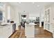 Spacious kitchen features an island with cooktop, ample counter space, stainless steel appliances, and an open layout at 11137 Peppermill Ln, Fishers, IN 46037