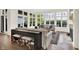 Bright living room features large windows with lake views, neutral furniture, and hardwood floors at 11137 Peppermill Ln, Fishers, IN 46037