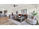 Living room with a fireplace, hardwood floors, neutral decor, and bar in the background at 11137 Peppermill Ln, Fishers, IN 46037