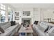 Bright living room featuring a cozy fireplace, large windows, and neutral-toned furniture for comfortable living at 11137 Peppermill Ln, Fishers, IN 46037