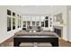 Spacious living room with large windows, natural light, fireplace, hardwood floors, and neutral furniture at 11137 Peppermill Ln, Fishers, IN 46037