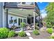 Covered outdoor patio featuring comfortable seating, ceiling fan, and beautiful landscaping at 11137 Peppermill Ln, Fishers, IN 46037