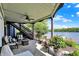 Inviting covered patio with ceiling fan, comfortable furniture, and views of the lake at 11137 Peppermill Ln, Fishers, IN 46037