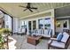Relaxing patio with a fire pit table and comfortable seating overlooking a serene lake at 11137 Peppermill Ln, Fishers, IN 46037