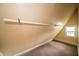 This attic includes a closet rod and a window at 11218 Exchange St, Indianapolis, IN 46259