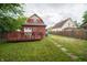 View of backyard featuring a wooden deck and a house that is adjacent to neighboring homes at 11218 Exchange St, Indianapolis, IN 46259