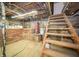 Unfinished basement with wooden staircase at 11218 Exchange St, Indianapolis, IN 46259
