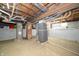 Unfinished basement featuring mechanicals and a brick support at 11218 Exchange St, Indianapolis, IN 46259
