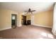 A spacious bedroom with ceiling fan and adjacent rooms at 11218 Exchange St, Indianapolis, IN 46259