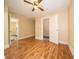 This room includes vinyl wood flooring, a ceiling fan, and two open doorways at 11218 Exchange St, Indianapolis, IN 46259