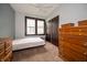 A simple bedroom with a large window for natural light and classic wood furnishings at 11218 Exchange St, Indianapolis, IN 46259