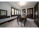 A dining room featuring a wood table, chairs, dark wood trim, and natural light at 11218 Exchange St, Indianapolis, IN 46259