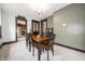A cozy dining room with wood table, chairs, and view to stainless steel kitchen appliances at 11218 Exchange St, Indianapolis, IN 46259