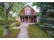 Charming two-story home with a welcoming front porch and well-maintained lawn and lovely mature trees at 11218 Exchange St, Indianapolis, IN 46259