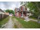 Charming two-story home with a covered front porch, adjacent to a driveway and a detached garage at 11218 Exchange St, Indianapolis, IN 46259