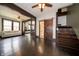 Spacious living room with hardwood floors, adjacent to staircase and bathroom with sliding door at 11218 Exchange St, Indianapolis, IN 46259