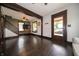 Cozy living room with hardwood floors and dark trim adjacent to doorway and staircase at 11218 Exchange St, Indianapolis, IN 46259