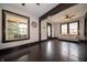 Bright living room featuring hardwood floors, a sofa, and large windows offering ample natural light at 11218 Exchange St, Indianapolis, IN 46259