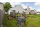 The backyard showcases a wooden deck, grassy lawn, perfect for outdoor enjoyment at 11620 Glenn Abbey Ln, Indianapolis, IN 46235