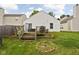 Cozy backyard features a deck, fire pit, and lush lawn, perfect for outdoor relaxation and entertaining at 11620 Glenn Abbey Ln, Indianapolis, IN 46235