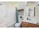 This bathroom is designed with a tub and shower combo and vanity sink at 11620 Glenn Abbey Ln, Indianapolis, IN 46235